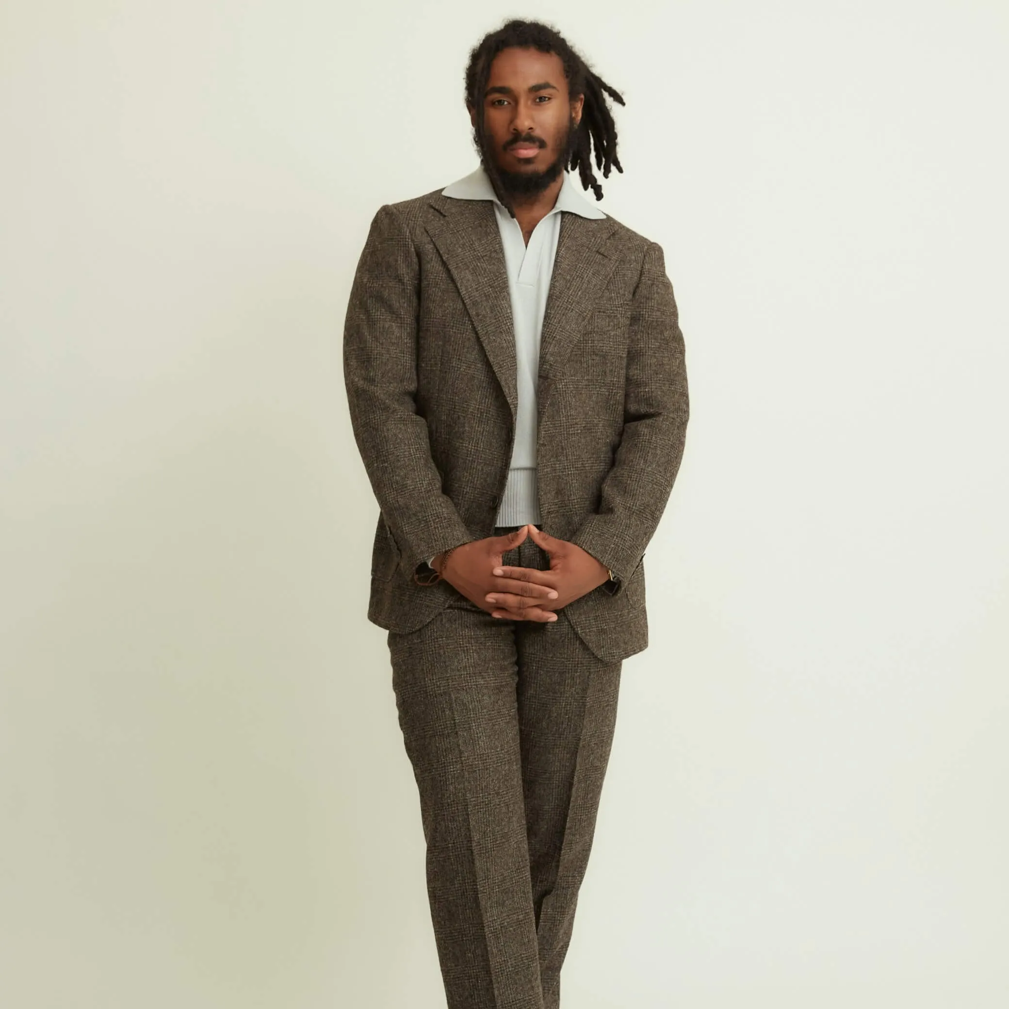 x Sartoria Carrara: Pleated trousers in tonal charcoal Prince-of-Wales undyed wool